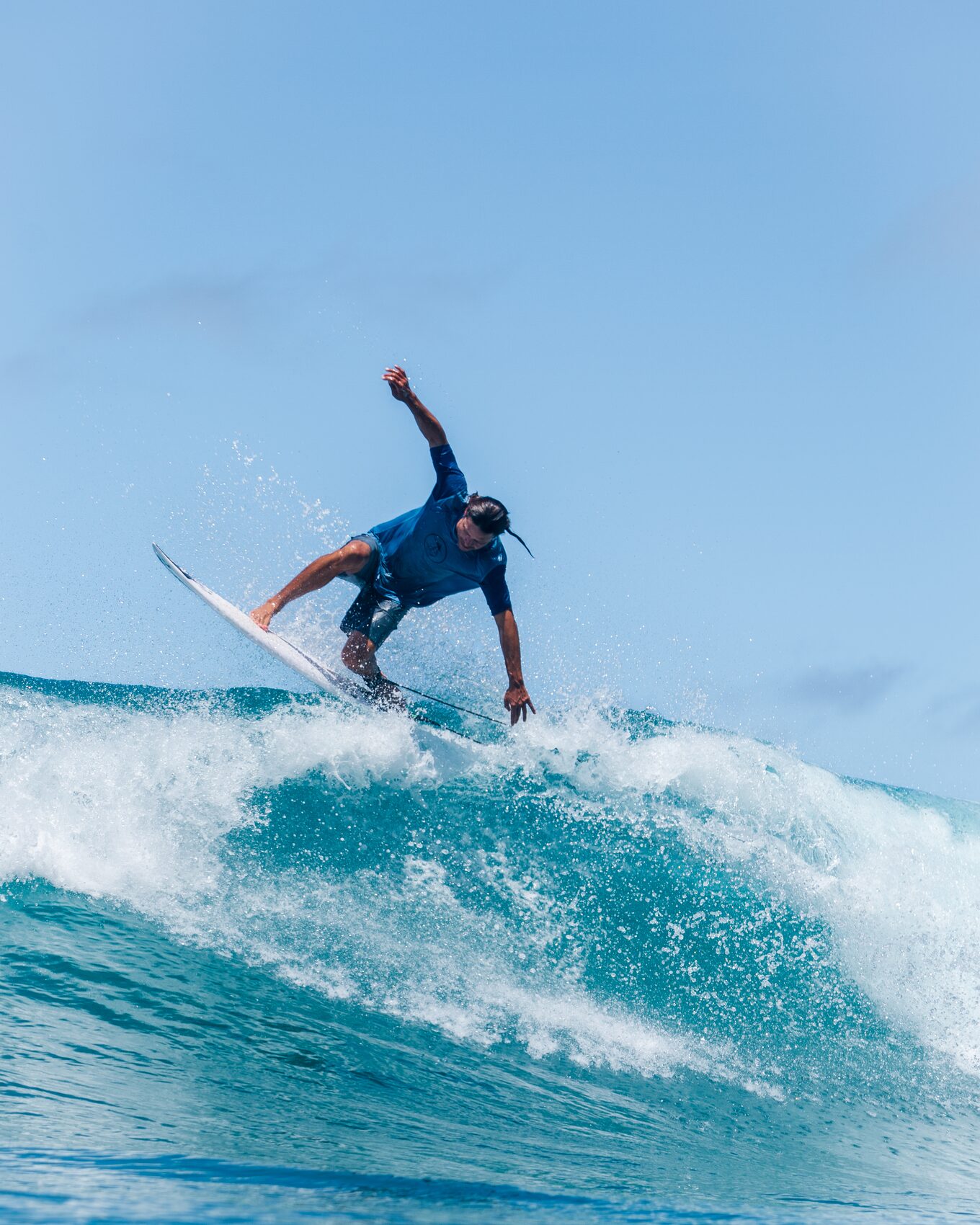 Surfer carving a cutback on a clean wave