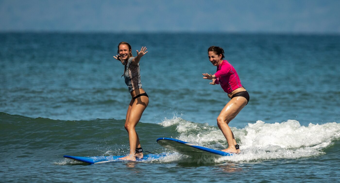 Beginner standing up and stoked on a wave